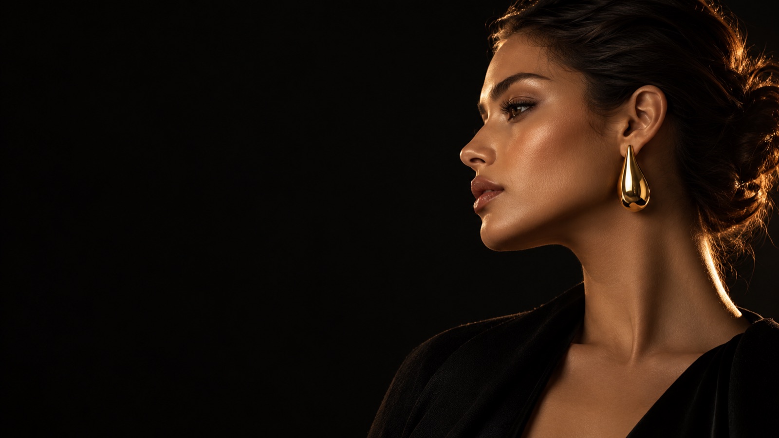 Model wearing gold drop earring